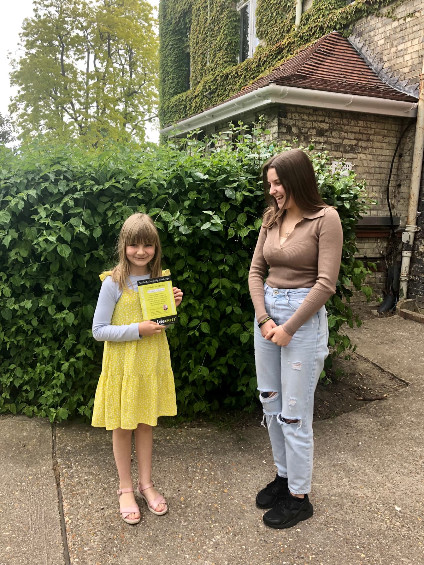 Skylar holding her 5asideCHESS World Citizenship Challenge Connect 5 certificate