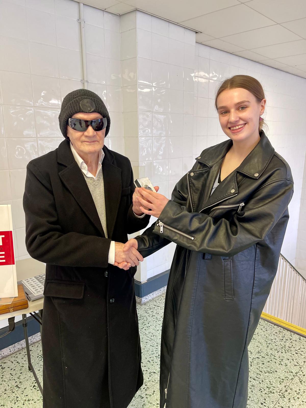Ciara shaking hands with John Healy as she receives her personalised 5asideCHESS Connect 25 medal