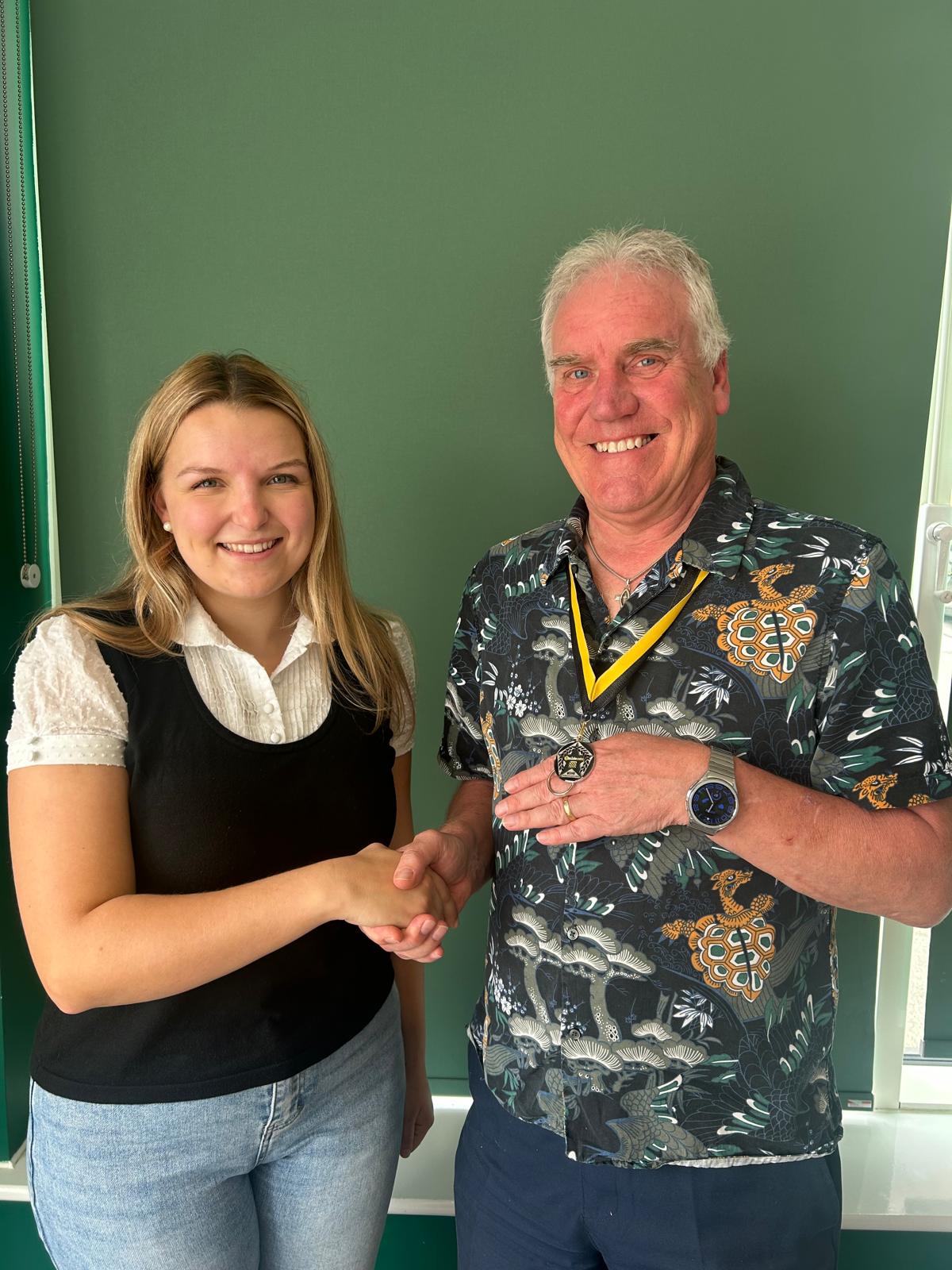 Graham wearing his personalised 5asideCHESS medal, shaking hands as he reaches Connect 25